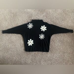 Black sweater with white flowers